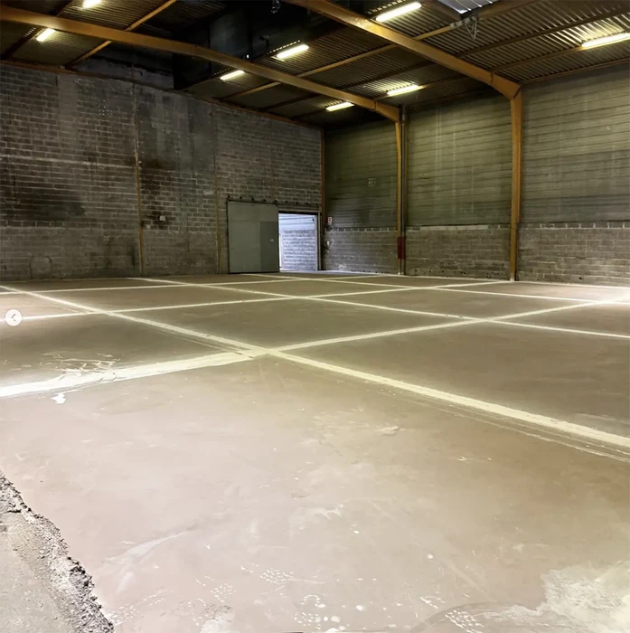 Intérieur d'un bâtiment commercial avec nettoyeur haute pression jaune Kärcher posé au sol